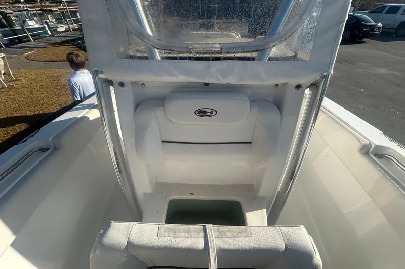 Slide: The Image of 2019 Sea Hunt Ultra 211 boat interior with seating and storage compartment. - 24