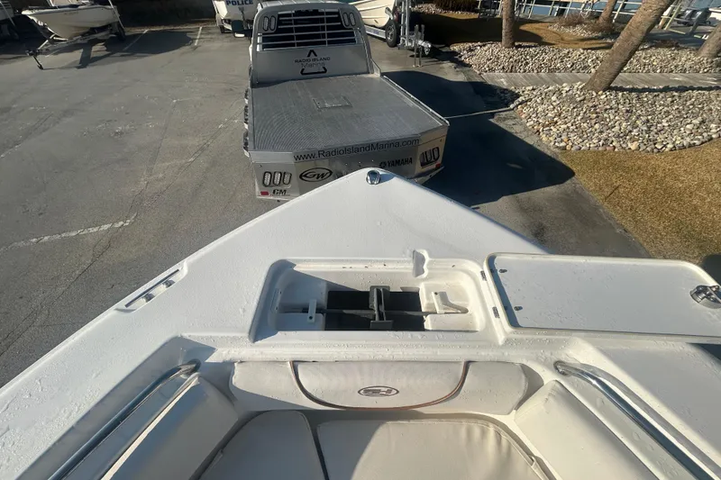 Slide: The Image of 2019 Sea Hunt Ultra 211 boat on trailer at marina parking lot. - 27