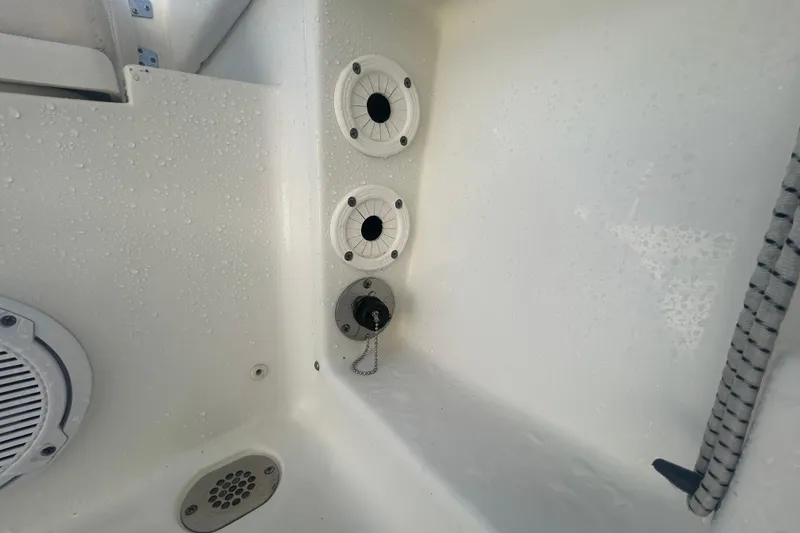 Slide: The Image of 2019 Sea Hunt Ultra 211 boat interior with wet surfaces and drainage features. - 28