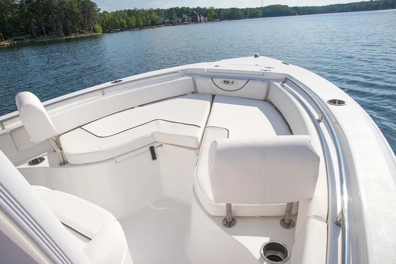 Slide: The Image of 2019 Sea Hunt Ultra 211 boat on trailer at marina with clear sky. - 3