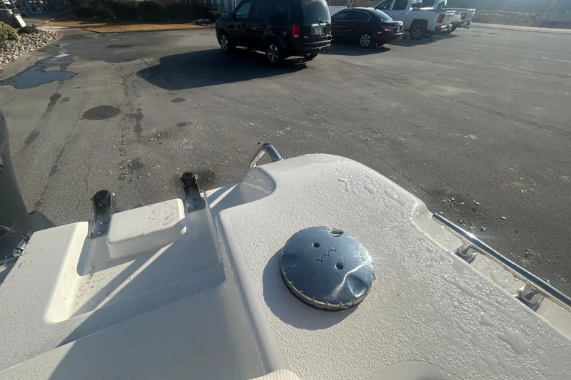 Slide: The Image of 2019 Sea Hunt Ultra 211 boat detail in parking lot with vehicles in background. - 31
