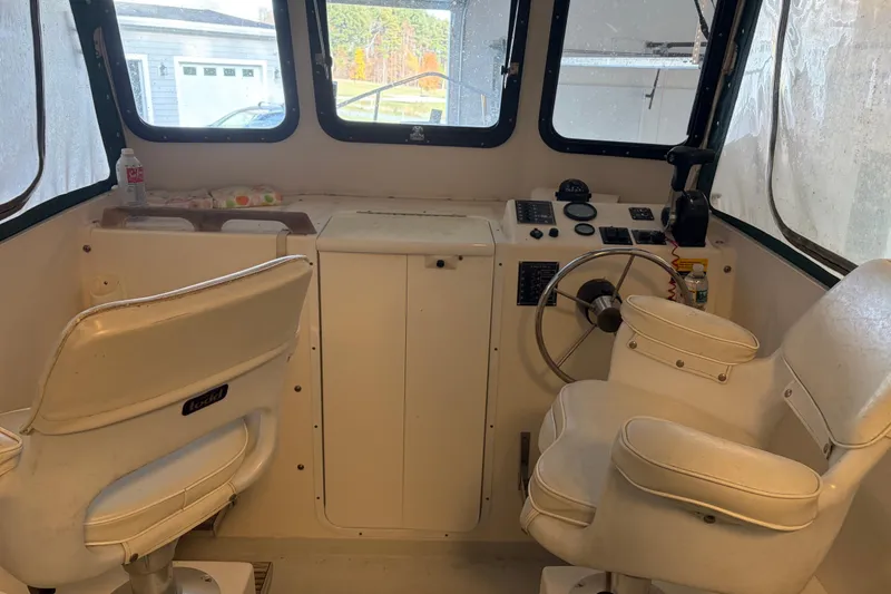 Slide: The Image of Interior of a 2007 Eastern 24 Lobster boat with steering wheel and seats. - 8