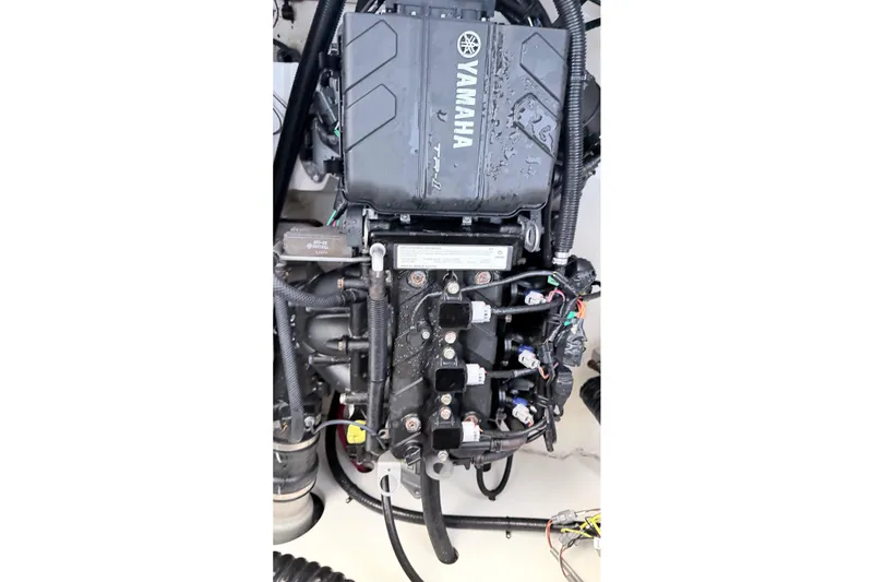 Slide: The Image of 2019 Yamaha AR210 boat engine, detailed view of components and wiring. - 10