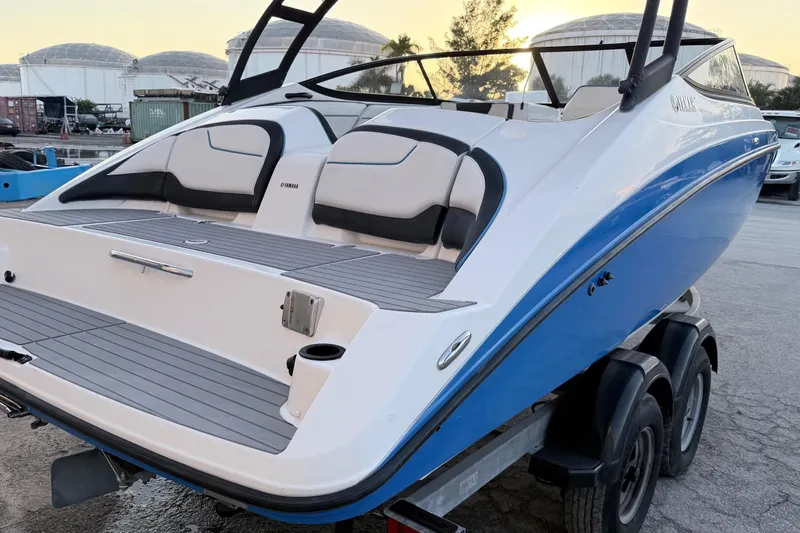 Slide: The Image of 2019 Yamaha Boats AR210 on trailer, featuring sleek design and spacious seating. - 3
