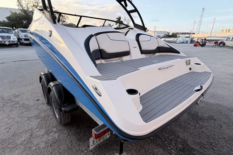 Slide: The Image of 2019 Yamaha Boats AR210 on trailer, rear view, showcasing sleek design and seating. - 4