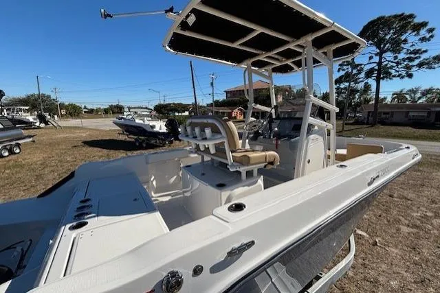 Slide: The Image of 2026 Bayliner Trophy T20CC boat with center console and seating, parked outdoors. - 12