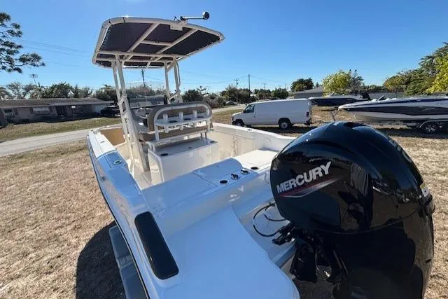 Slide: The Image of 2026 Bayliner Trophy T20CC boat with Mercury engine, parked outdoors. - 13