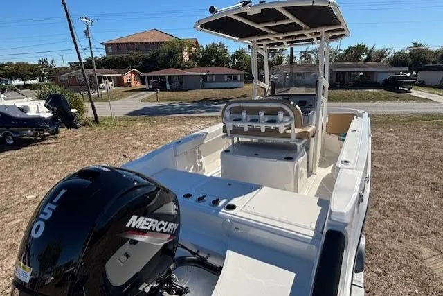 Slide: The Image of 2026 Bayliner Trophy T20CC boat with Mercury engine, parked outdoors on grass. - 14