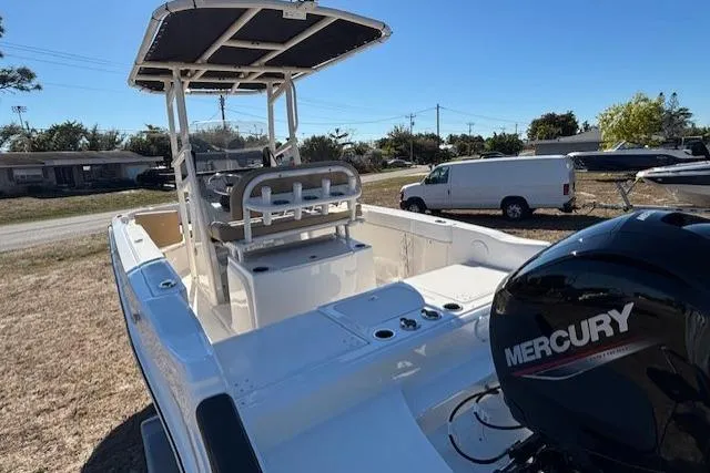 Slide: The Image of 2026 Bayliner Trophy T20CC boat with Mercury engine, parked outdoors. - 15
