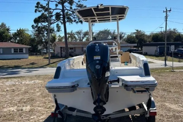 Slide: The Image of 2026 Bayliner Trophy T20CC boat with outboard motor, parked on a trailer in a residential area. - 8