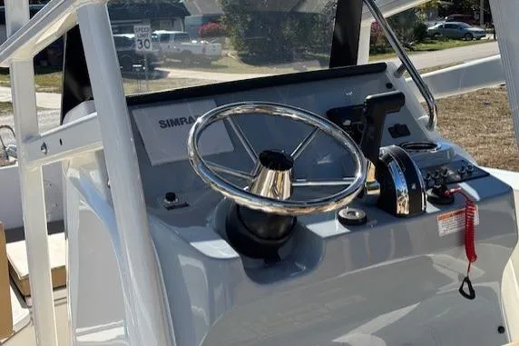 Slide: The Image of 2026 Bayliner Trophy T20CC boat console with steering wheel and controls. - 9