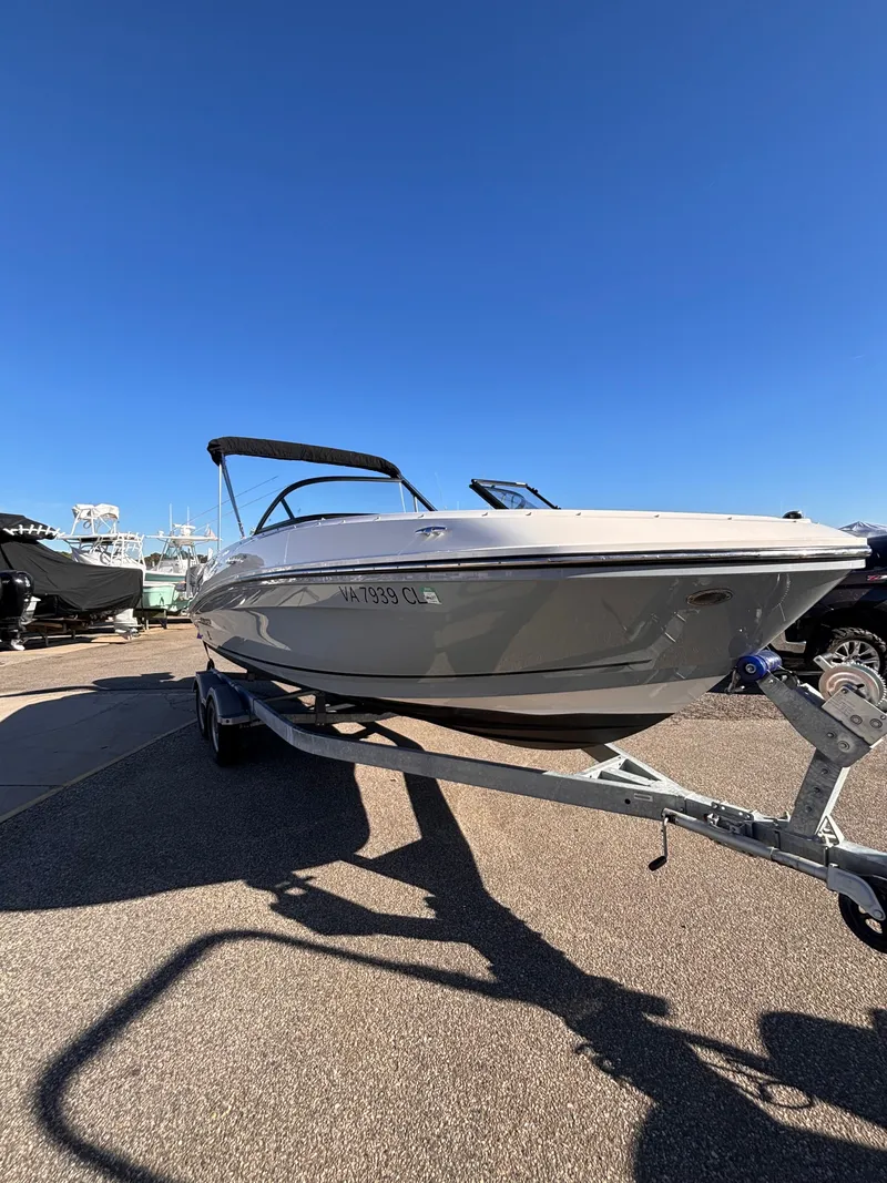 Slide: The Image of 2024 Bayliner VR6 Bowrider OB on trailer, blue sky. - 10