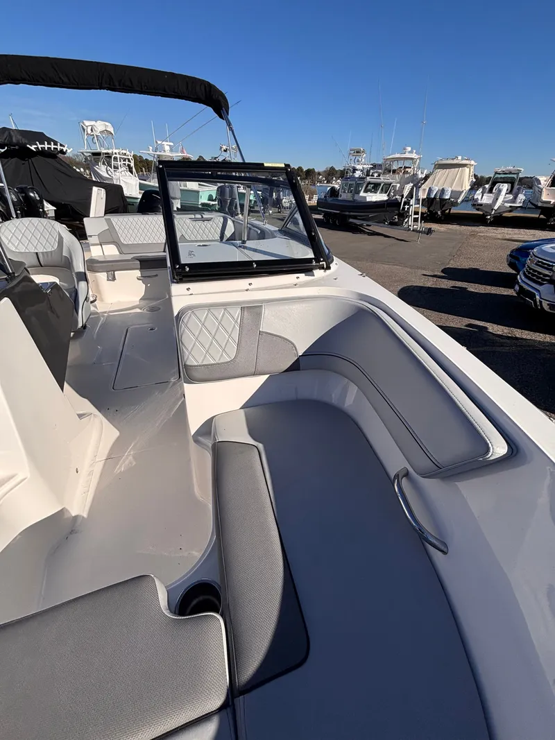 Slide: The Image of 2024 Bayliner VR6 Bowrider OB with gray seating at the marina. - 4