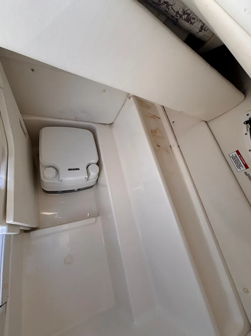 Slide: The Image of Interior of 2024 Bayliner VR6 Bowrider OB with storage space. - 5