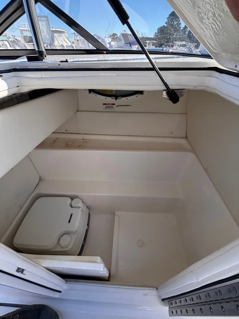 Slide: The Image of Interior of 2024 Bayliner VR6 Bowrider OB with storage space. - 6