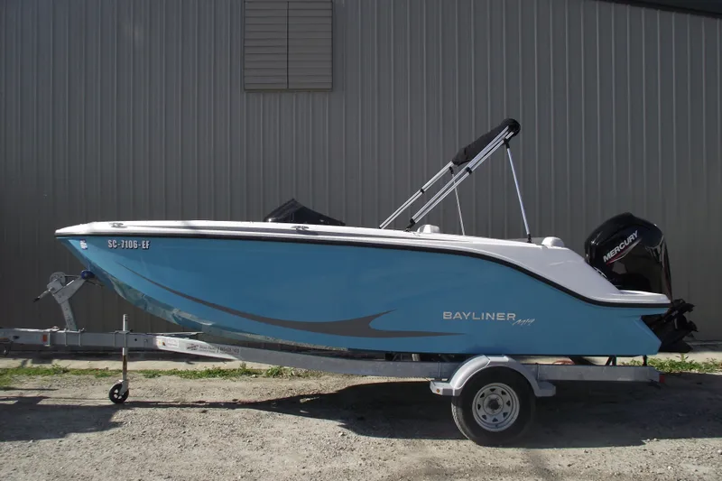 The Image of 2024 Bayliner Element M19 boat on trailer, blue hull, parked outdoors. - 0