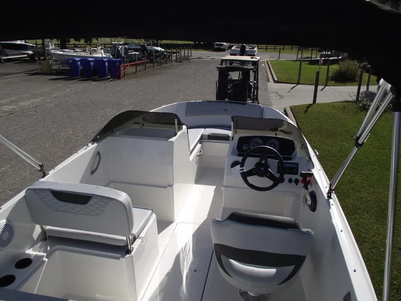 Slide: The Image of 2024 Bayliner Element M19 boat interior with seating and steering console. - 8