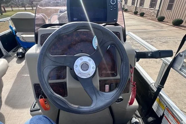 Slide: The Image of Steering wheel of 2020 Sun Tracker Bass Buggy 16 DLX boat with control panel. - 11