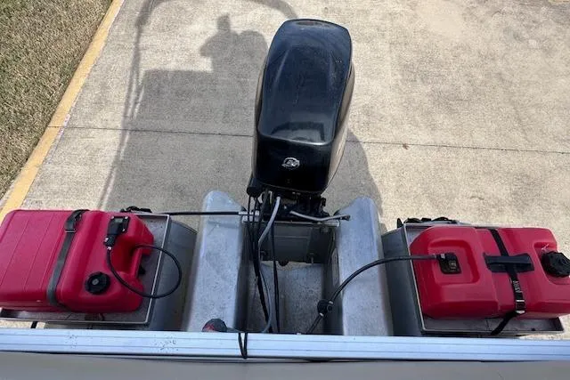 Slide: The Image of 2020 Sun Tracker Bass Buggy 16 DLX with dual red fuel tanks and outboard motor. - 14