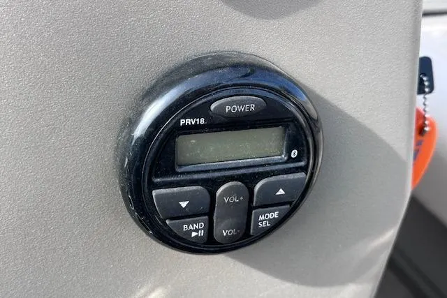 Slide: The Image of Control panel of a 2020 Sun Tracker Bass Buggy 16 DLX boat, featuring power and volume buttons. - 16