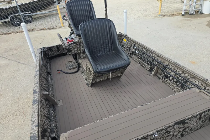 Slide: The Image of 2026 Pro-Drive 1854 SBX TD boat interior with two black seats and camouflage design. - 11