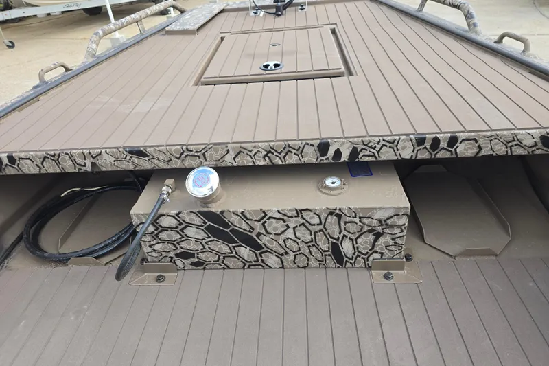 Slide: The Image of 2026 Pro-Drive 1854 SBX TD boat interior with camouflage design and storage compartment. - 12