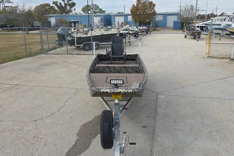 Slide: The Image of 2026 Pro-Drive 1854 SBX TD boat on trailer in a boatyard setting. - 3