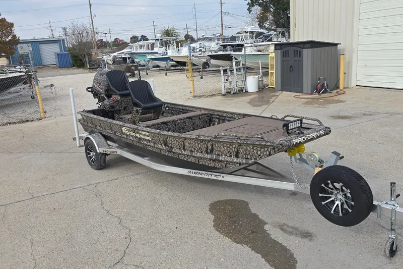 Slide: The Image of 2026 Pro-Drive 1854 SBX TD boat on trailer, parked in a marina lot. - 4