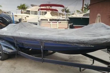 Slide: The Image of 2018 Skeeter FX21 Limited Edition boat covered, parked in a marina with other boats. - 13