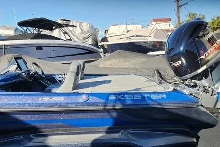 Slide: The Image of 2018 Skeeter FX21 Limited Edition boat with Yamaha VMAX 250 engine, parked among other boats. - 15