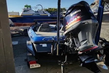 Slide: The Image of 2018 Skeeter FX21 Limited Edition boat with Yamaha engine, parked in a marina. - 19