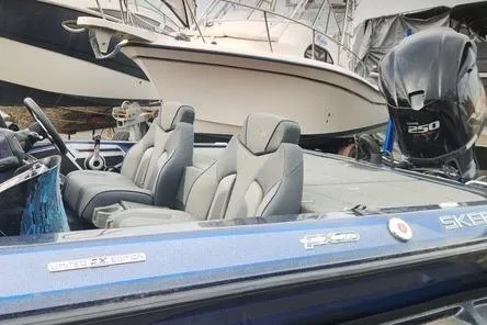 Slide: The Image of 2018 Skeeter FX21 Limited Edition boat with Yamaha 250 engine, docked beside another vessel. - 5
