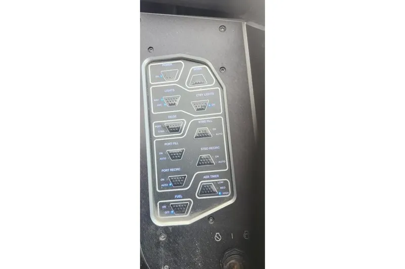 Slide: The Image of Control panel of a 2018 Skeeter FX21 Limited Edition boat, featuring various switches. - 8