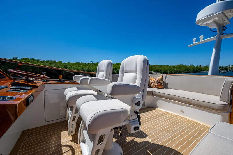 Slide: The Image of Luxury seating on 2021 Hinckley Talaria yacht with clear blue sky backdrop. - 13