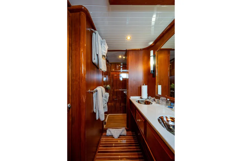Slide: The Image of Luxurious 2021 Hinckley Talaria yacht bathroom with wooden finishes and modern amenities. - 27
