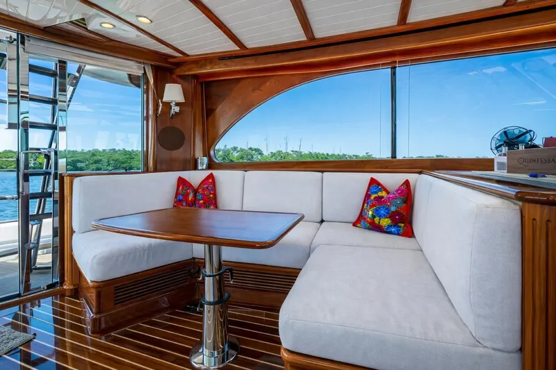 Slide: The Image of Luxurious 2021 Hinckley Talaria yacht interior with elegant wood finish and plush seating. - 18