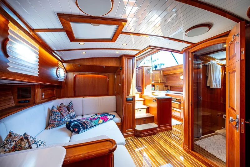 Slide: The Image of Luxurious 2021 Hinckley Talaria yacht interior with elegant wood finishes and cozy seating area. - 22