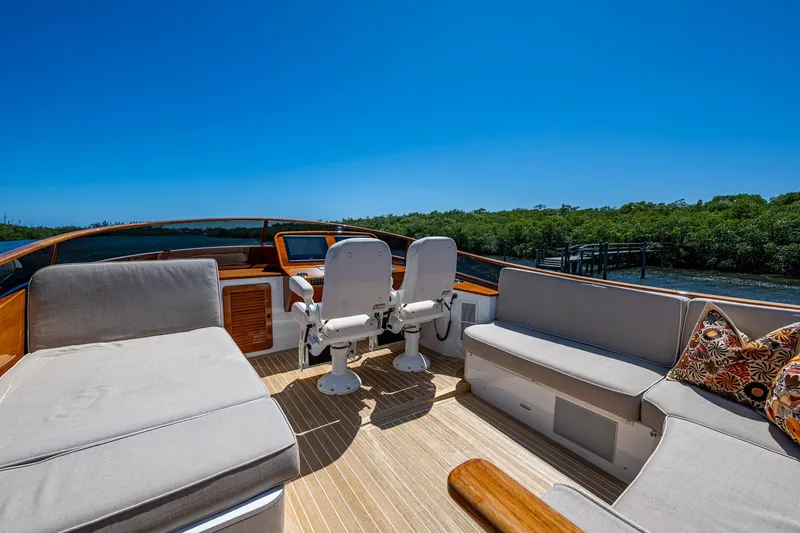 Slide: The Image of Luxurious 2021 Hinckley Talaria yacht interior with plush seating and scenic water view. - 11