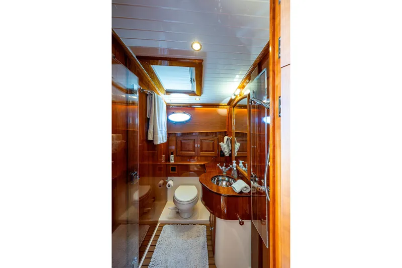Slide: The Image of Luxurious 2021 Hinckley Talaria yacht bathroom with elegant wood finish and modern fixtures. - 24