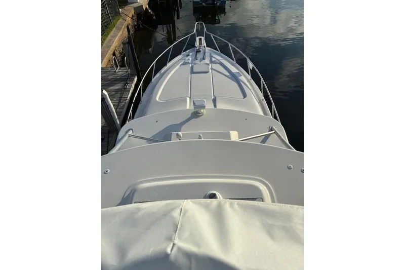 Slide: The Image of 2007 Bertram 360 boat deck view at dockside, calm water reflection. - 10