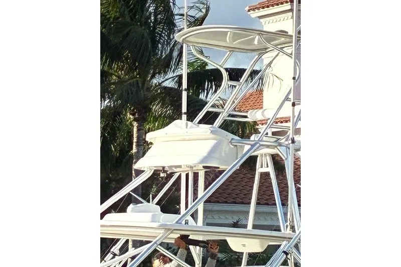 Slide: The Image of Tower of a 2007 Bertram 360 boat with palm trees in the background. - 12