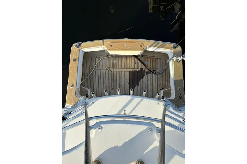 Slide: The Image of 2007 Bertram 360 boat deck with wooden finish and metal railings. - 14