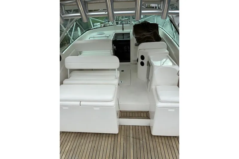 Slide: The Image of 2007 Bertram 360 boat interior with white seating and wooden deck. - 19