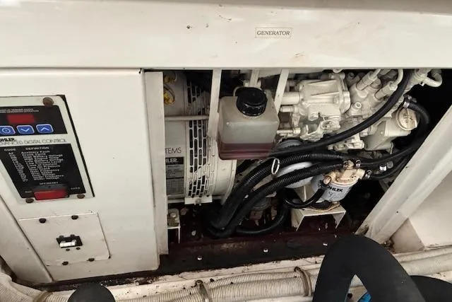Slide: The Image of Engine compartment of a 2007 Bertram 360 boat, featuring generator and control panel. - 25