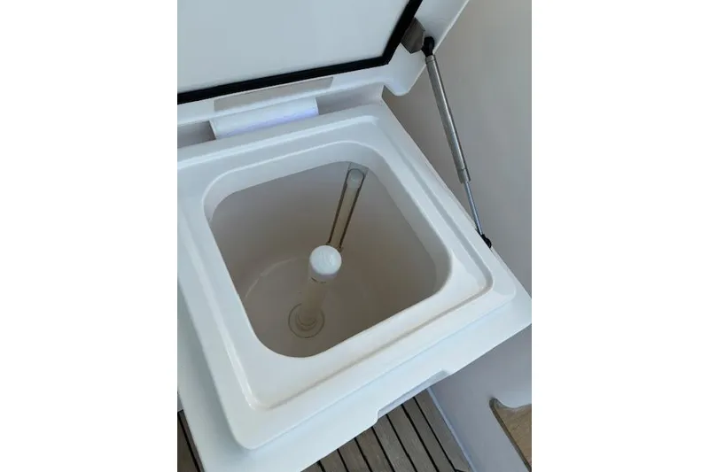 Slide: The Image of Open storage compartment on 2007 Bertram 360 boat, featuring a hydraulic lift. - 27