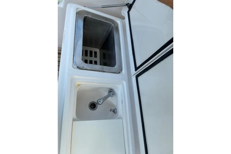 Slide: The Image of 2007 Bertram 360 boat sink and storage compartment. - 28