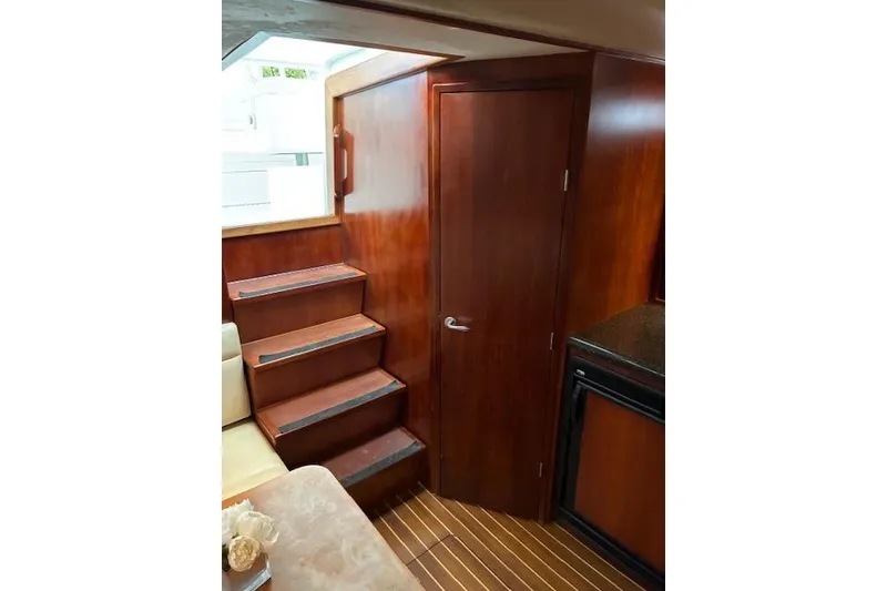 Slide: The Image of Interior of 2007 Bertram 360 yacht with wooden stairs and door. - 36