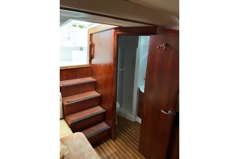 Slide: The Image of 2007 Bertram 360 interior with wooden stairs and bathroom door. - 37