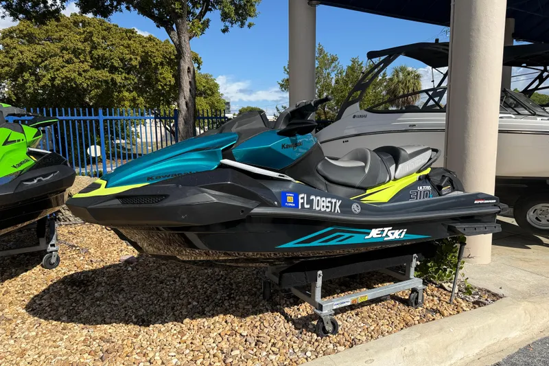 The Image of 2023 Kawasaki Ultra Jet Ski displayed outdoors on a stand. - 0