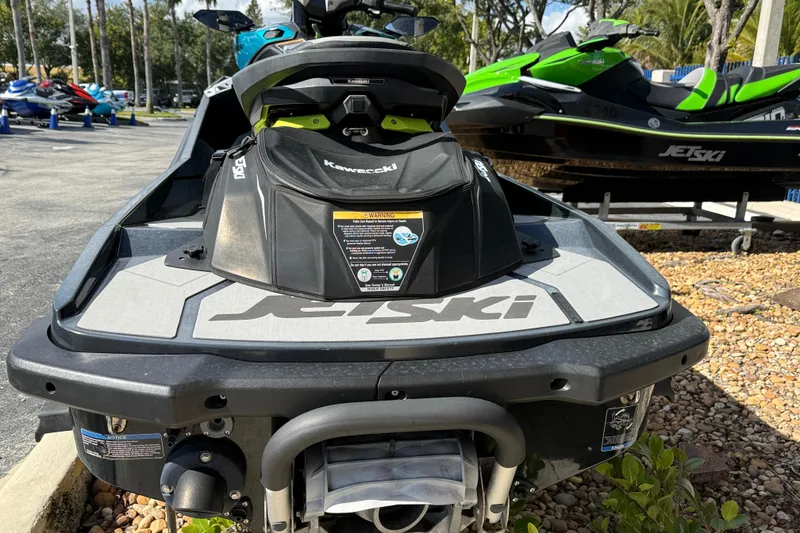 Slide: The Image of 2023 Kawasaki Ultra Jet Ski displayed outdoors, showcasing rear design and branding. - 13